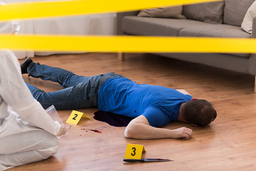 Image showing criminalist collecting evidence at crime scene