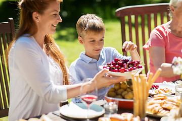 Image showing happy family having dinner or summer garden party