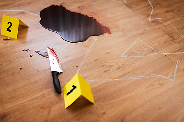 Image showing chalk outline and knife in blood at crime scene