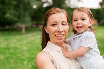 Image showing mother with baby girl taking selfie at summer park