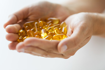 Image showing hands holding cod liver oil capsules