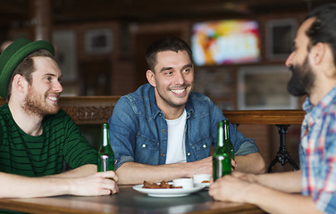 Image showing happy male friends drinking beer at bar or pub