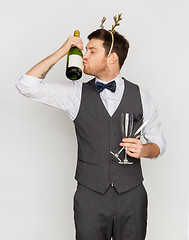 Image showing man kissing bottle of champagne at christmas party