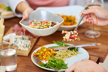 Image showing people eating salad at table with food