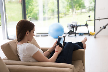 Image showing woman sitting on sofa with tablet computer