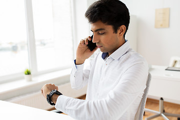 Image showing businessman calling on smartphone at office