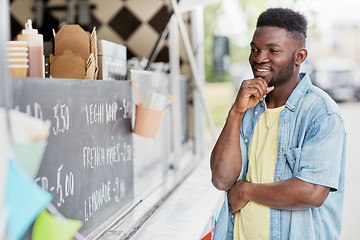 Image showing male customer looking at billboard at food truck