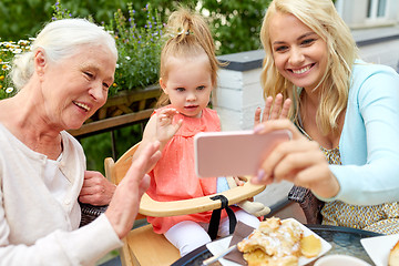 Image showing happy family taking selfie at cafe