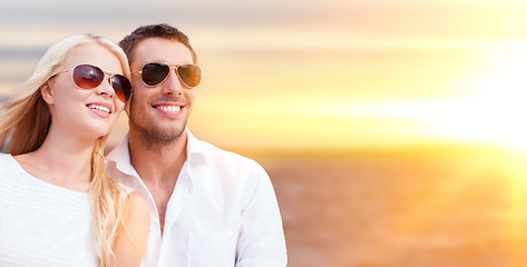 Image showing happy couple in sunglasses over sea background