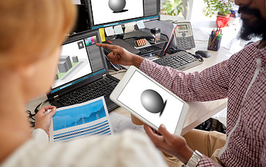 Image showing designers with 3d models on laptop and tablet pc