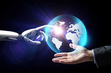 Image showing human and robot hand with virtual earth hologram