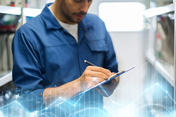 Image showing auto mechanic with clipboard at car workshop