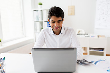 Image showing businessman with laptop and papers at office