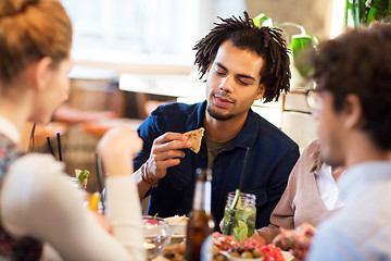 Image showing man with friends eating at restaurant