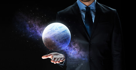 Image showing close up of businessman with planet hologram