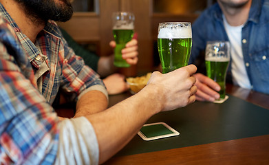 Image showing male friends drinking green beer at bar or pub