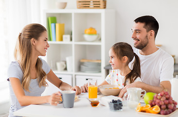 Image showing happy family having breakfast at home