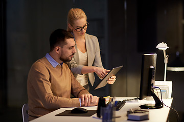 Image showing business team with tablet pc late at office