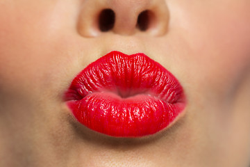 Image showing woman lips with red lipstick making kiss 