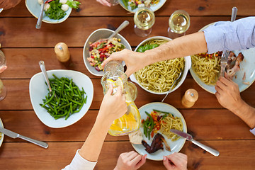 Image showing people at table with food eating and drinking