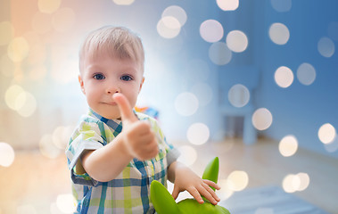 Image showing happy baby boy playing with toy showing thumbs up