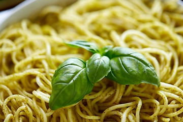 Image showing close up of cooked pasta with basil leaves