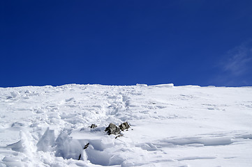 Image showing Top of snowy mountains with footpath and blue sky