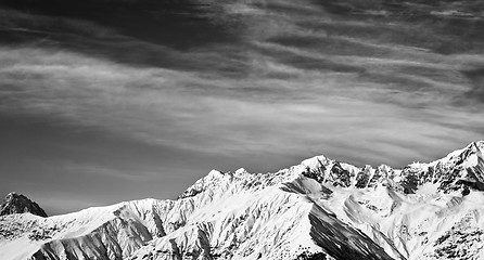Image showing Black and white panoramic view on winter mountains at sun winter