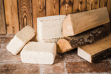 Image showing Wood briquette and firewood, close-up