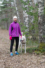 Image showing Sporty woman with a dog in the park