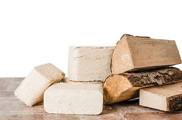 Image showing Wood briquette and firewood, close-up