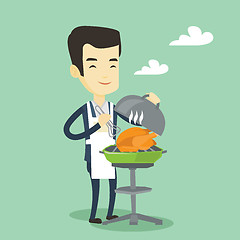 Image showing Man cooking chicken on barbecue grill.