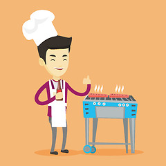 Image showing Man cooking steak on barbecue grill.