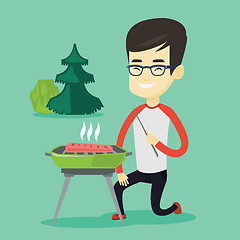 Image showing Man cooking steak on barbecue grill.