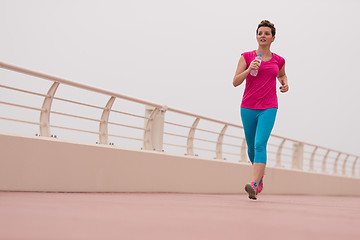 Image showing woman busy running on the promenade