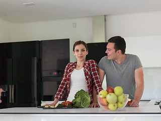 Image showing Young handsome couple in the kitchen