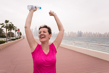 Image showing young woman celebrating a successful training run