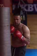 Image showing kick boxer training on a punching bag