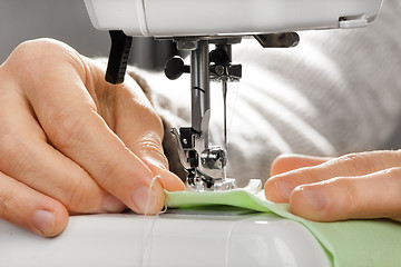 Image showing hands working on the sewing machine