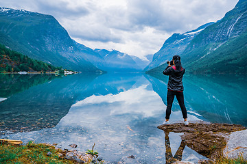 Image showing Nature photographer tourist with camera shoots lovatnet lake Bea