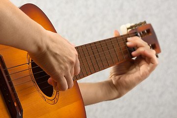 Image showing hands playing acoustic guitar