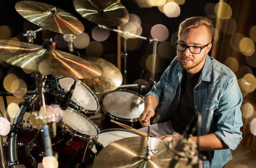 Image showing male musician playing drums and cymbals at concert