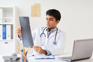 Image showing doctor looking at spine x-ray scan at clinic