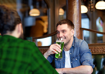 Image showing male friends drinking green beer at bar or pub