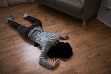 Image showing dead woman body in blood on floor at crime scene