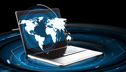 Image showing world map hologram and laptop computer