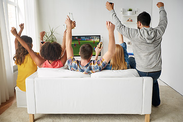 Image showing friends with beer watching soccer on tv at home