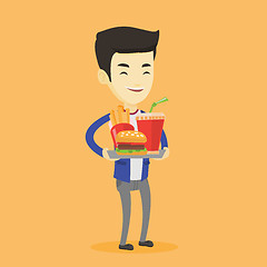 Image showing Man holding tray full of fast food.