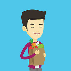 Image showing Happy man holding grocery shopping bag.