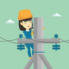 Image showing Electrician working on electric power pole.